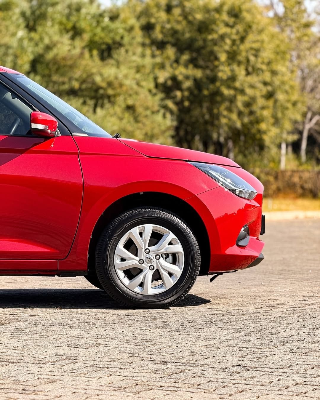 The side view of a red suzuki