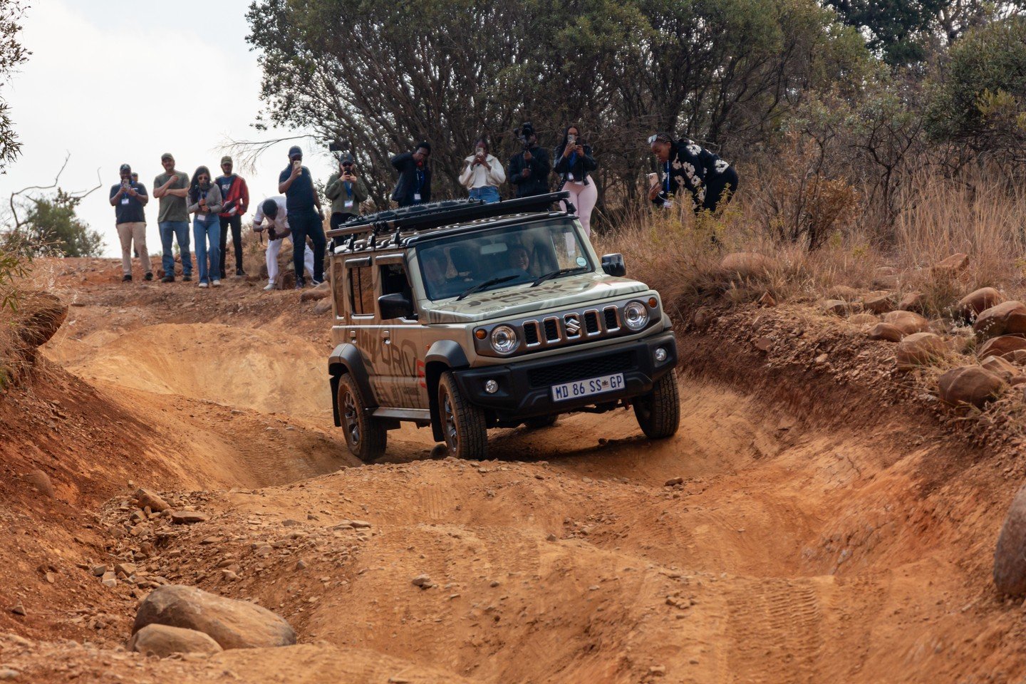 Suzuki Jimny driving through dirt
